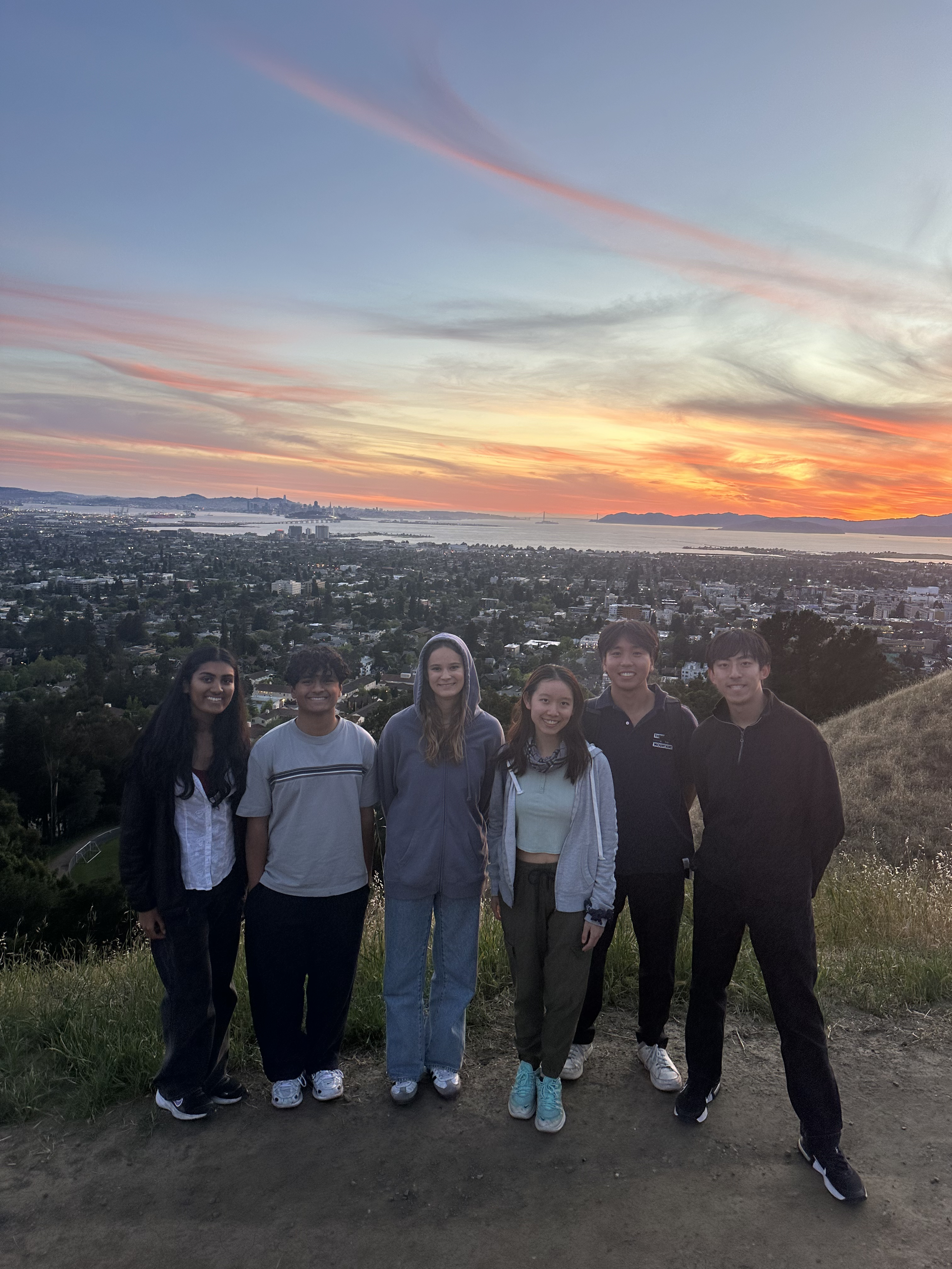 Consulting committee members watching the sunset together on a hike overlooking the Bay Area