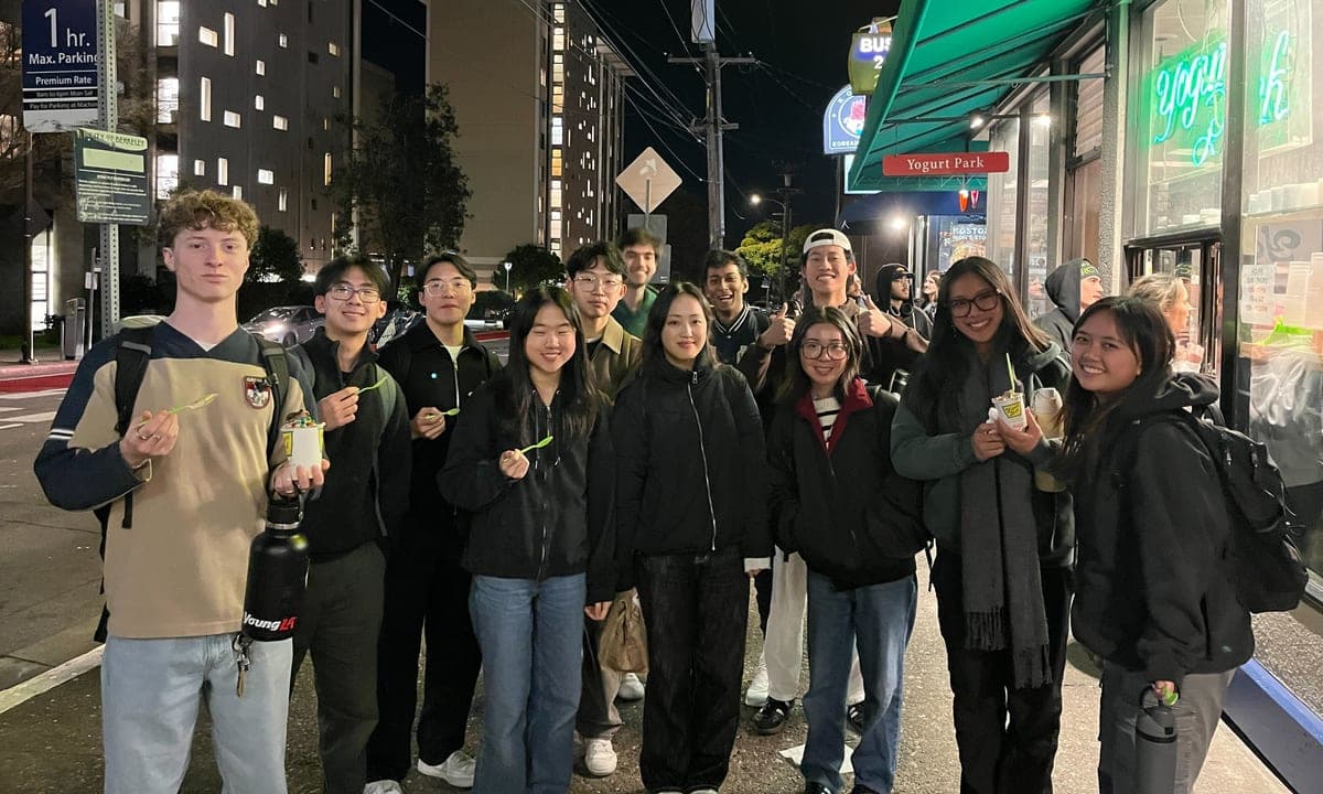 New DSS members out together on Durant Avenue in Berkeley at night, holding cups of frozen yogurt